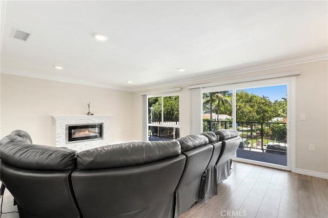 3034 Via Vis Unit A, Laguna Woods, CA 92637 - living area with light wood-style flooring, ornamental molding, a glass covered fireplace, and recessed lighting