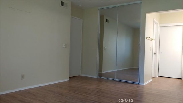 17305 Rosewood, Irvine, CA 92612 - unfurnished bedroom with wood finished floors and a closet