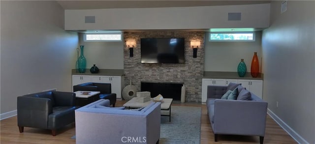 17305 Rosewood, Irvine, CA 92612 - living room featuring light wood-style flooring, plenty of natural light, and a fireplace