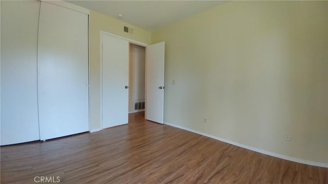 17305 Rosewood, Irvine, CA 92612 - unfurnished bedroom featuring wood finished floors and a closet