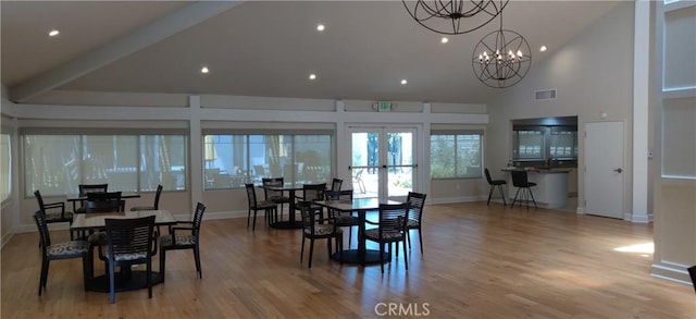 17305 Rosewood, Irvine, CA 92612 - dining area featuring high vaulted ceiling, wood finished floors, a chandelier, recessed lighting, and french doors