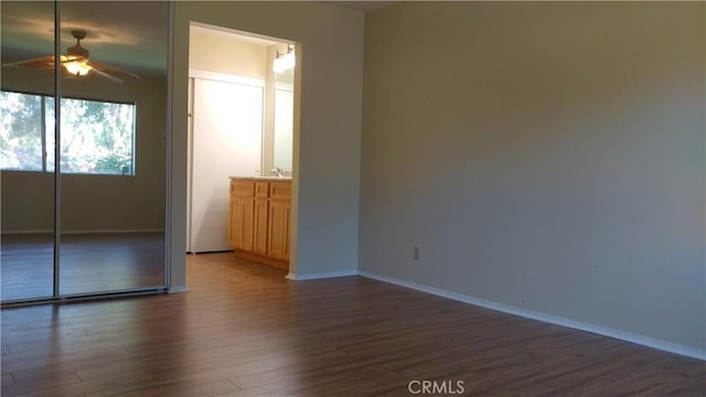 17305 Rosewood, Irvine, CA 92612 - unfurnished bedroom with dark wood-style floors and baseboards