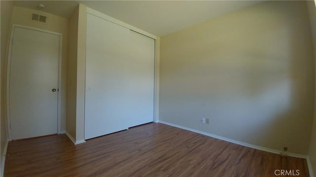 17305 Rosewood, Irvine, CA 92612 - unfurnished bedroom featuring wood finished floors and a closet