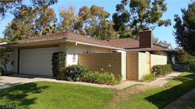 17305 Rosewood, Irvine, CA 92612 - view of home's exterior featuring a chimney, an attached garage, stucco siding, and concrete driveway