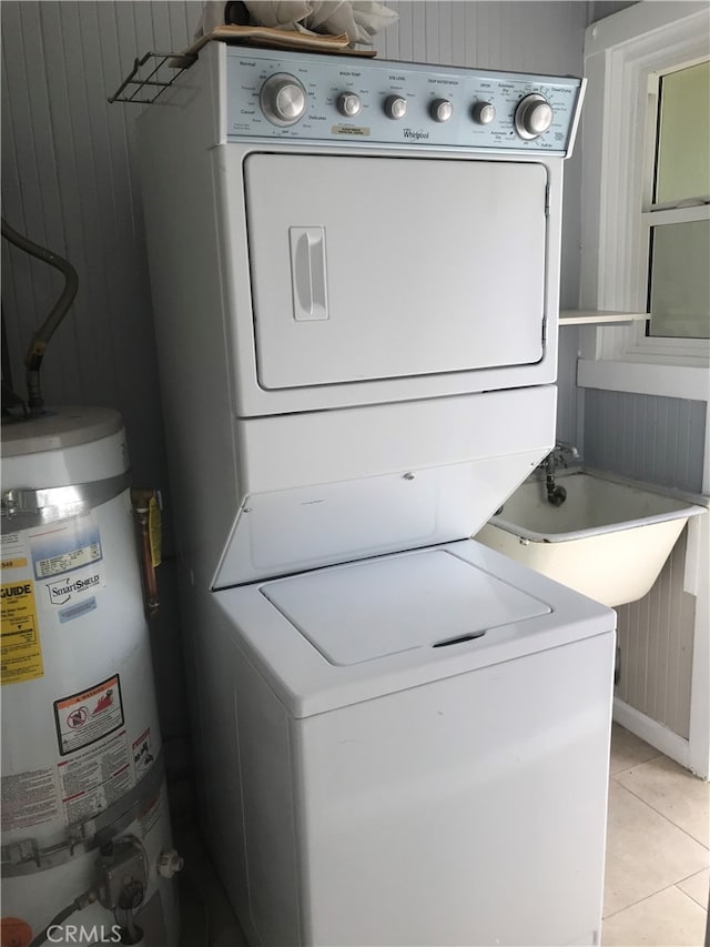 254 E Glenarm St, Pasadena, CA 91106 - washroom with stacked washing machine and dryer, water heater, and light tile patterned flooring