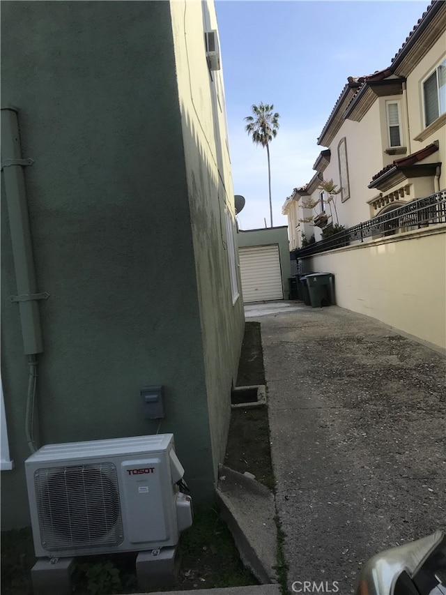 254 E Glenarm St, Pasadena, CA 91106 - view of side of home featuring a cooling unit and stucco siding