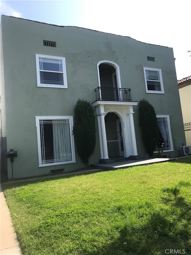 254 E Glenarm St, Pasadena, CA 91106 - rear view of house with a balcony, a lawn, and stucco siding