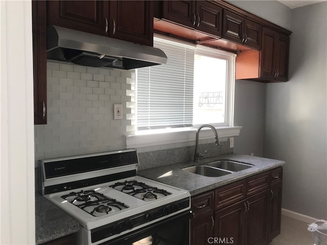 254 E Glenarm St, Pasadena, CA 91106 - kitchen with gas range gas stove, under cabinet range hood, light stone counters, decorative backsplash, and dark brown cabinets