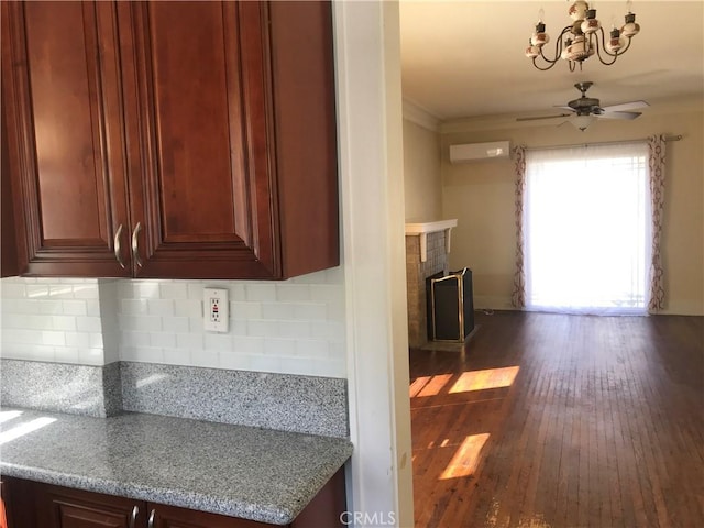 254 E Glenarm St, Pasadena, CA 91106 - kitchen with a chandelier, an AC wall unit, ceiling fan, a brick fireplace, and dark wood finished floors