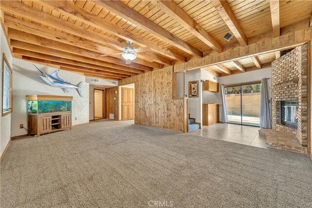 2528 Key Ct, Lancaster, CA 93536 - unfurnished living room with a wooden ceiling with exposed beams, a fireplace, ceiling fan, carpet floors, and stairway