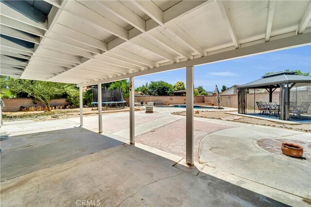 2528 Key Ct, Lancaster, CA 93536 - fenced backyard featuring a trampoline, a gazebo, a patio, and outdoor dining area