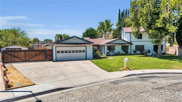 2528 Key Ct, Lancaster, CA 93536 - view of front of property with an attached garage, stucco siding, driveway, and a gate
