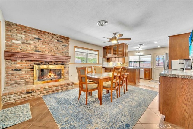 2528 Key Ct, Lancaster, CA 93536 - dining room with light tile patterned flooring, a ceiling fan, healthy amount of natural light, and a textured ceiling