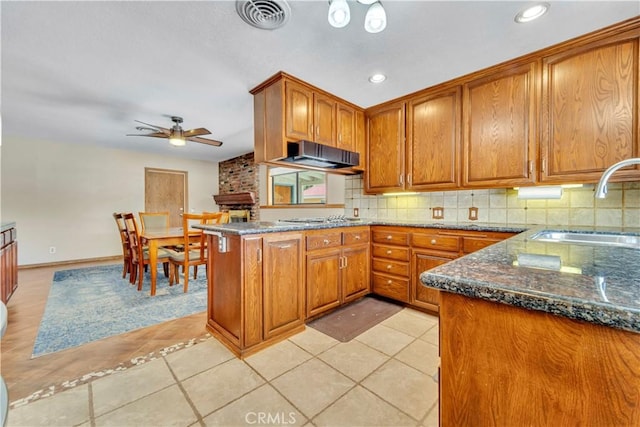 2528 Key Ct, Lancaster, CA 93536 - kitchen featuring brown cabinets, a ceiling fan, tasteful backsplash, dark stone countertops, and light tile patterned flooring
