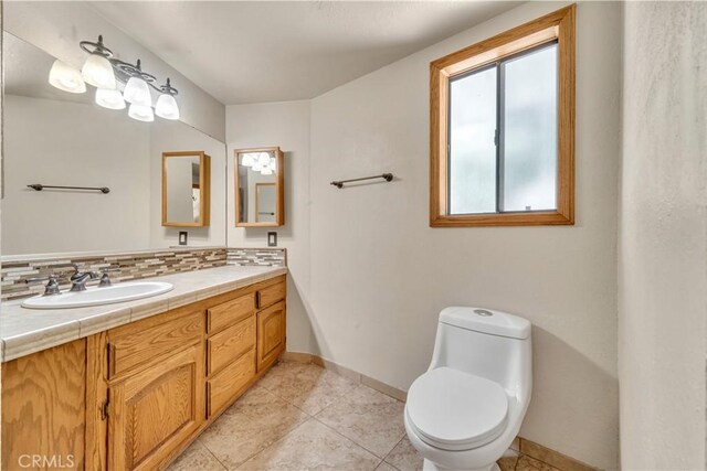 2528 Key Ct, Lancaster, CA 93536 - bathroom featuring double vanity, backsplash, and tile patterned flooring