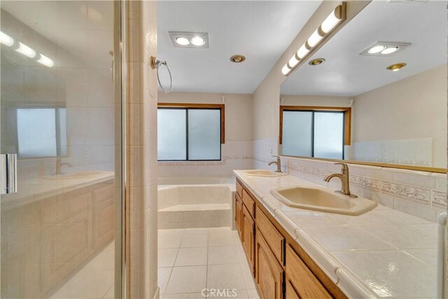 2528 Key Ct, Lancaster, CA 93536 - bathroom with tile patterned flooring, a bath, plenty of natural light, and double vanity
