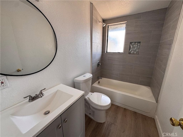 541 Frances Dr, Barstow, CA 92311 - bathroom featuring wood finished floors, vanity, bathing tub / shower combination, and a textured wall