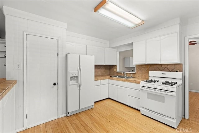 1869 Thrush Rd, Wrightwood, CA 92397 - kitchen featuring white appliances, tile countertops, white cabinets, light wood-type flooring, and tasteful backsplash