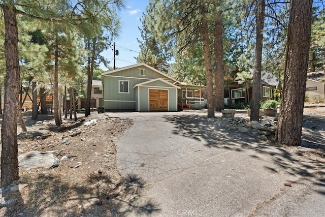 1869 Thrush Rd, Wrightwood, CA 92397 - view of front of property featuring an attached garage, driveway, and board and batten siding