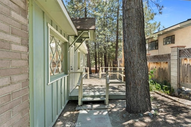 1869 Thrush Rd, Wrightwood, CA 92397 - doorway to property featuring board and batten siding and a wooden deck