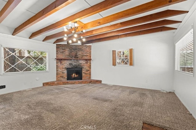 1869 Thrush Rd, Wrightwood, CA 92397 - unfurnished living room featuring plenty of natural light, beam ceiling, carpet, and a brick fireplace