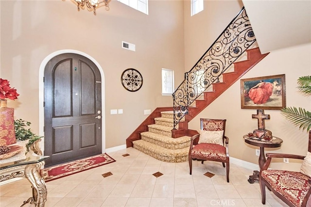 1482 Fergus, Claremont, CA 91711 - foyer featuring arched walkways, light tile patterned floors, stairs, a towering ceiling, and a chandelier