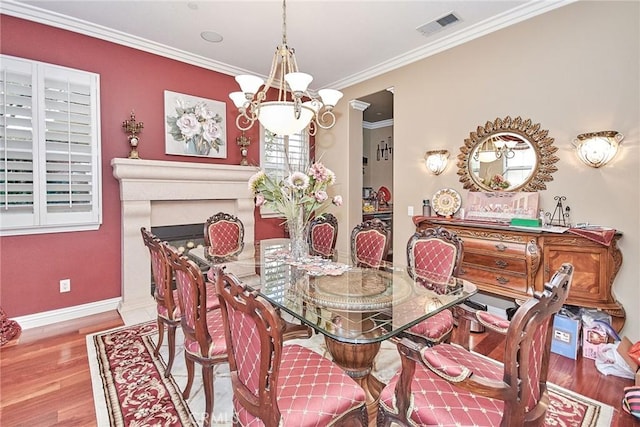 1482 Fergus, Claremont, CA 91711 - dining room with wood finished floors, ornamental molding, a chandelier, and a fireplace