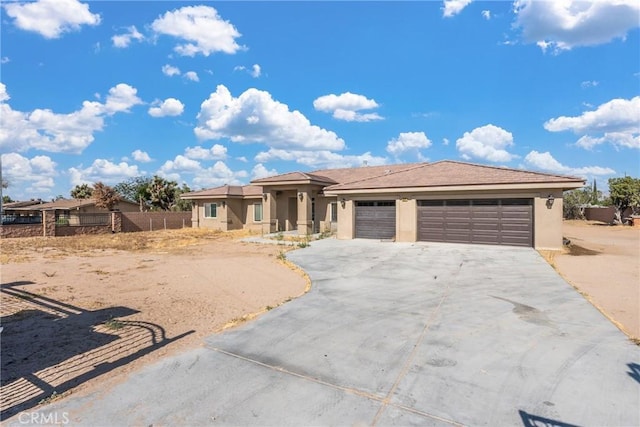 9121 6th Ave, Hesperia, CA 92345 - prairie-style home with stucco siding, an attached garage, and concrete driveway