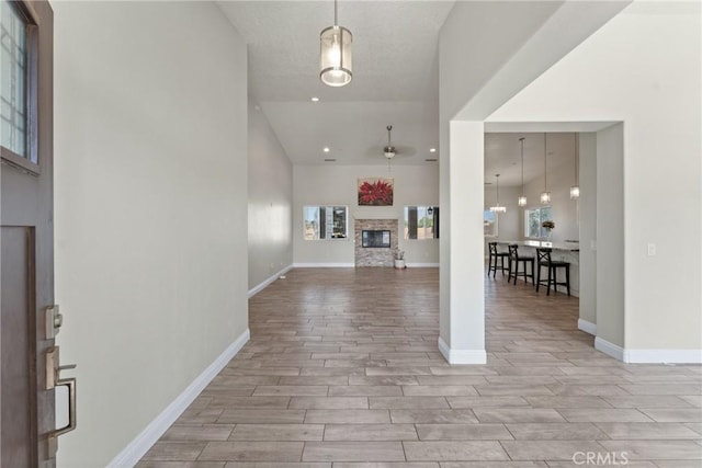 9121 6th Ave, Hesperia, CA 92345 - entryway featuring wood finished floors, a stone fireplace, recessed lighting, and high vaulted ceiling