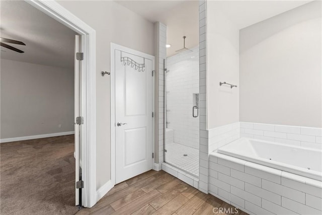 9121 6th Ave, Hesperia, CA 92345 - bathroom featuring a shower stall, a tub with jets, ceiling fan, and wood finished floors