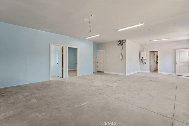 9121 6th Ave, Hesperia, CA 92345 - unfurnished room featuring concrete flooring and water heater