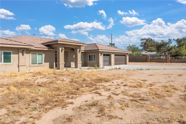 9121 6th Ave, Hesperia, CA 92345 - view of front of property featuring an attached garage, stucco siding, and driveway