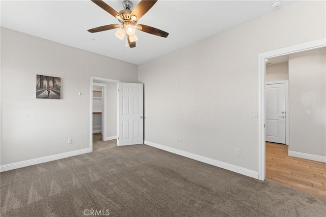 9121 6th Ave, Hesperia, CA 92345 - unfurnished bedroom with carpet, a walk in closet, ceiling fan, and a closet