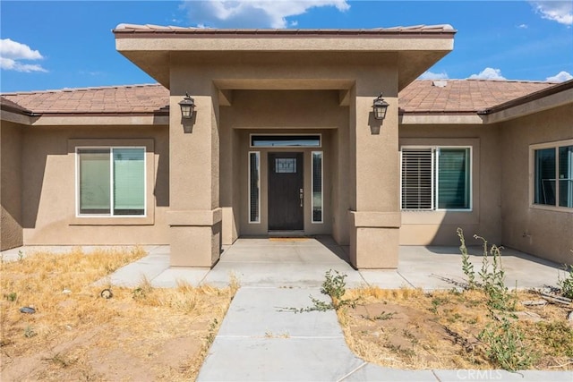 9121 6th Ave, Hesperia, CA 92345 - property entrance with stucco siding and a tiled roof