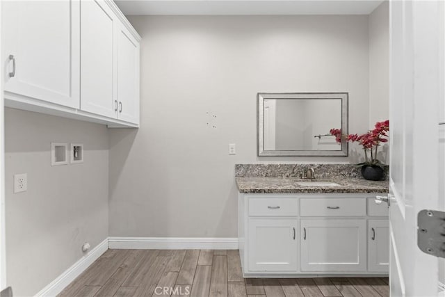 9121 6th Ave, Hesperia, CA 92345 - laundry area featuring cabinet space, light wood-type flooring, and washer hookup