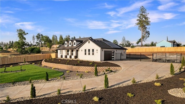 5500 Harrison Rd, Paradise, CA 95969 - view of side of home with solar panels, stucco siding, a garage, and concrete driveway