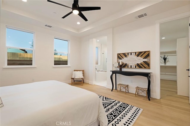 5500 Harrison Rd, Paradise, CA 95969 - bedroom with wood finished floors, recessed lighting, a tray ceiling, a spacious closet, and connected bathroom