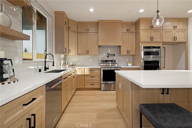 5500 Harrison Rd, Paradise, CA 95969 - kitchen with stainless steel appliances, light brown cabinets, light wood finished floors, a kitchen breakfast bar, and light countertops