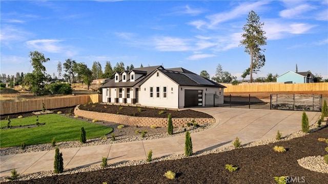 5500 Harrison Rd, Paradise, CA 95969 - view of side of home featuring roof mounted solar panels, stucco siding, a garage, and concrete driveway