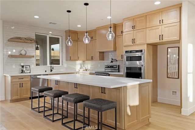 5500 Harrison Rd, Paradise, CA 95969 - kitchen featuring stainless steel appliances, light brown cabinetry, decorative backsplash, light wood-type flooring, and recessed lighting