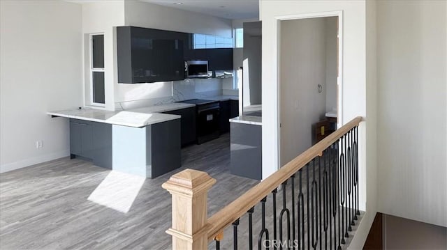 1296 Saratoga Ave, Grover Beach, CA 93433 - kitchen featuring stainless steel microwave, modern cabinets, light wood-type flooring, and light countertops