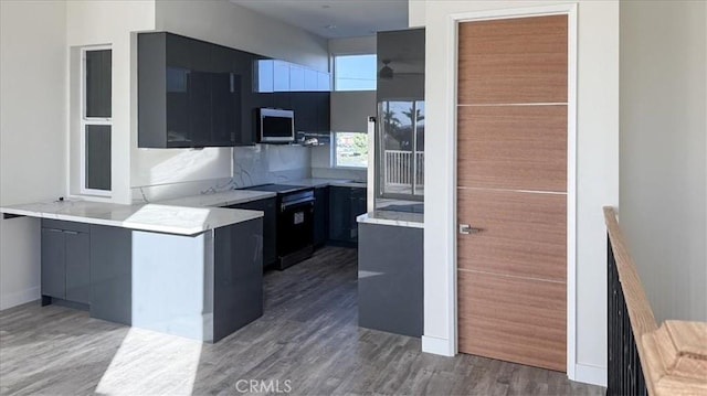 1296 Saratoga Ave, Grover Beach, CA 93433 - kitchen with stainless steel microwave, modern cabinets, wood finished floors, and light countertops