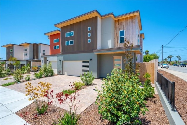 1296 Saratoga Ave, Grover Beach, CA 93433 - modern home featuring an attached garage, stucco siding, and driveway