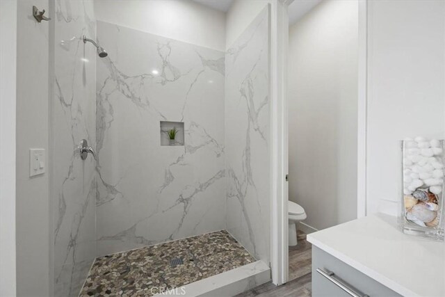 1296 Saratoga Ave, Grover Beach, CA 93433 - full bathroom featuring wood finished floors, a marble finish shower, and vanity