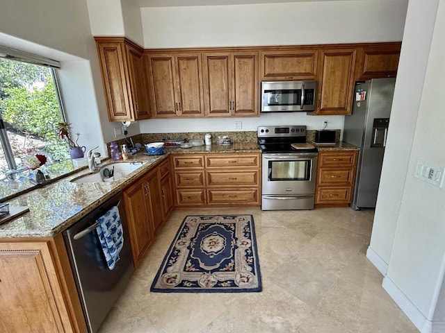 4150 Pindar Way, Oceanside, CA 92056 - kitchen with appliances with stainless steel finishes, brown cabinetry, and stone countertops