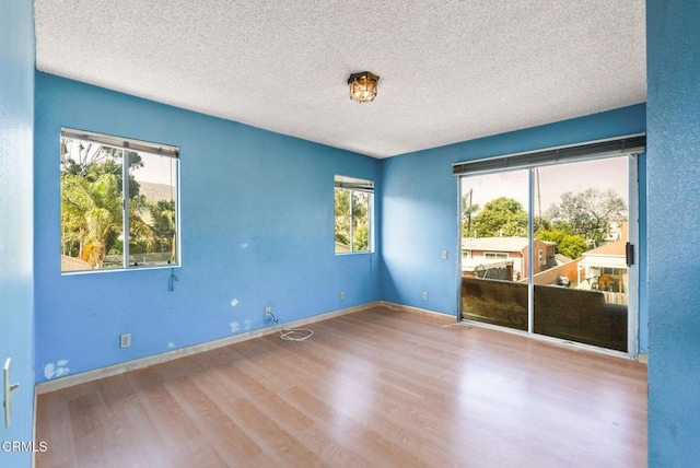 236 S 11th St, Santa Paula, CA 93060 - unfurnished room featuring a textured ceiling, plenty of natural light, and wood finished floors
