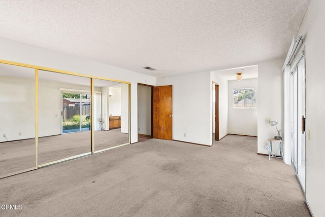 236 S 11th St, Santa Paula, CA 93060 - unfurnished bedroom featuring carpet flooring, a textured ceiling, and multiple closets