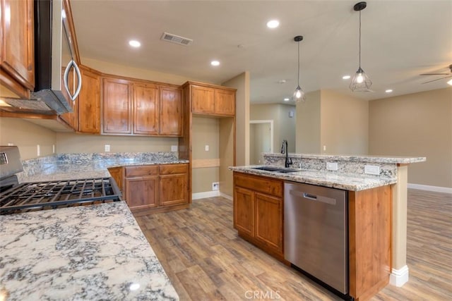 1910 Crandall Way, Paradise, CA 95969 - kitchen with appliances with stainless steel finishes, light wood-style flooring, brown cabinetry, and recessed lighting