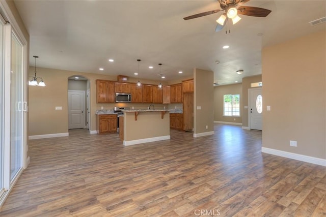 1910 Crandall Way, Paradise, CA 95969 - kitchen featuring open floor plan, stainless steel microwave, wood finished floors, recessed lighting, and a ceiling fan