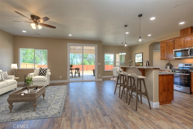 1910 Crandall Way, Paradise, CA 95969 - living room featuring healthy amount of natural light, wood finished floors, arched walkways, recessed lighting, and ceiling fan